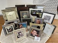 Front view of multiple assorted picture frames grouped together showing a variety of colors and styles.