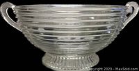 Front view of clear horizontal ribbed glass serving bowl with open handles and ribbed pedestal base