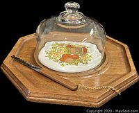 Side perspective showing octagonal wood tray, glass dome cover with colorful design, and attached serrated knife.