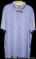 Full view of men's blue paisley golf shirt with collar and buttons visible