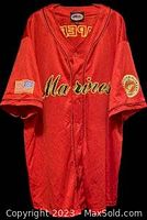 Red knit short sleeve jersey with 'Marines' script on the front and patches on sleeves.