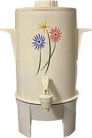 Side view of the off-white vintage Regal percolator urn with colorful flower design and spigot.