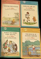 Four vintage Winnie-The-Pooh paperback chapter books by A.A. Milne, each with illustrated cover art by Ernest H. Shepard.