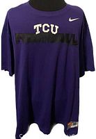 Front view of purple Nike TCU football t-shirt with white TCU lettering and black FOOTBALL print.