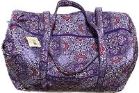 Top view of the large Vera Bradley duffel bag showing the zippered main compartment and two top handles, decorated in lilac tapestry floral pattern.