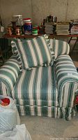 Front view of the armchair showing striped upholstery and cushion.