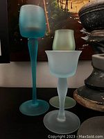 Photo showing the three frosted glass candle holders arranged by height, highlighting the blue, green, and white frosted colors and shapes.