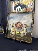 Frontal photo of square wooden framed wall art showing two seated dogs facing opposite directions with central decorative clock design.