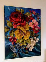 Photo of original acrylic painted canvas art showing colorful floral bouquet on blue background