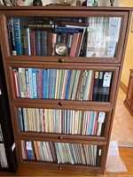 Front view showing four glass-fronted compartments with books inside