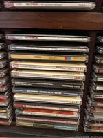 Close-up of stacked CDs in one column showing classical composer names on spines