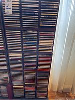 Three columns of CDs in jewel cases on shelving, predominantly classical music CDs.