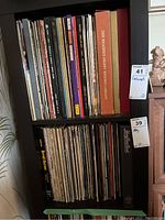 Two shelves filled with a large collection of LP records showing varied album spines including box sets.