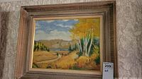 Full view of framed landscape painting showing autumn trees, river, hills and sky