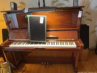 Front view showing keyboard, music stand, pedals