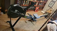 Full side view of the Concept2 PM3 rowing machine set up on carpet