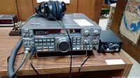 Kenwood TS-440S HF transceiver with attached microphone and headphones