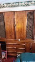 Full front view of the two-piece hutch showing wood-paneled and lattice grille doors with drawers below