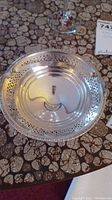 Top view of sterling silver decorative dish showing pierced edge and concentric circles.