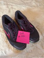 Angle view of Brooks ladies sneakers size 9 showing the front and side profile, with mesh upper and pink Brooks logo.