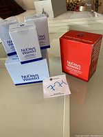 Multiple packets of No Days Wasted DHM Detox and Hydration Replenisher supplements arranged on surface.