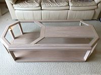 Top view of the coffee table showing the unique geometric-shaped beveled glass insets within the whitewashed wood frame.