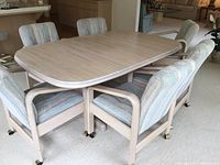 Dining table and 6 chairs set, showing table top and chair design, white washed wood finish and upholstery fabric.