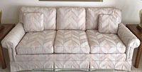 Front view of the three-seat couch showing overall shape, cushions, and chevron patterned upholstery.
