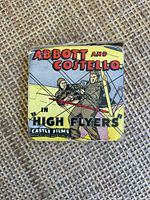 Close up of one film sleeve showing Abbott and Costello with airplane rigging and vintage colorful graphics.