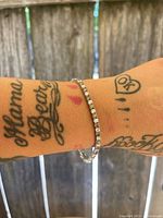 Bracelet displayed on wrist showing the full length and sparkle of the cubic zirconia stones, close-up view.