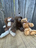 Photo showing three plush animals including two bears and one bird with detailed view on fabric texture and condition