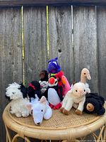 Wide shot of all plush animals on wicker surface