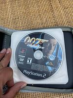 PlayStation 2 game disc titled '007 Nightfire' featuring a picture of James Bond