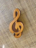 Top view of the wooden trinket box shaped as a treble clef music note, showing cut-out details and smooth wood finish.