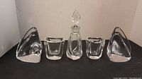 Set of two crystal bookends, two small vases, and one lidded container shown from front