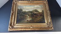 Front view of framed painting depicting a riverside water mill and waterfall