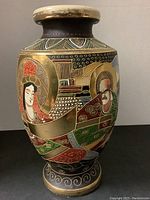 Full side view of the Satsuma vase showing a woman figure with red headdress and gold halo.