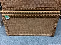 Closed wicker trunk showing tightly woven wicker exterior in natural coloring.
