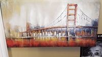 Front view of large cityscape mixed media painting showing suspension bridge and city skyline