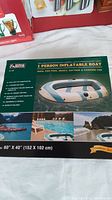 Box showing 1 person inflatable boat with product images and usage suggestions in pool and beach environments.