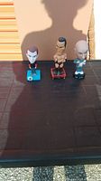 Full lot of three bobble heads shown together: Sheldon, The Rock, Dr. Evil