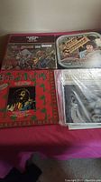 Lot of 4 vintage vinyl LP records laid out together showing front covers including Bob Marley and Marvin Gaye