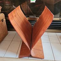Front view of vintage bentwood magazine rack showing the curved V-shape design to hold magazines upright.