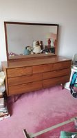 Front view of nine-drawer dresser with attached mirror