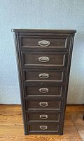 Front view of chest showing 7 drawers and silver bail handles.