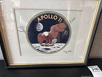 Framed Apollo 11 insignia print with signatures visible