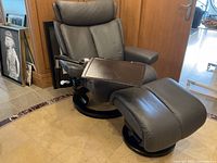 Side view of recliner chair with ottoman and tray table