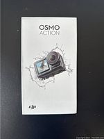 Front of sealed DJI Osmo Action box showing camera in waterproof housing graphic and branding