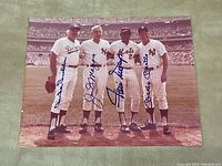 Full view of the signed photograph showing four players lined up on the field