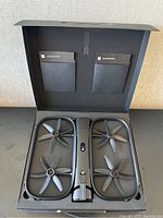 Open foam-lined carrying case with drone centered and propeller guards visible